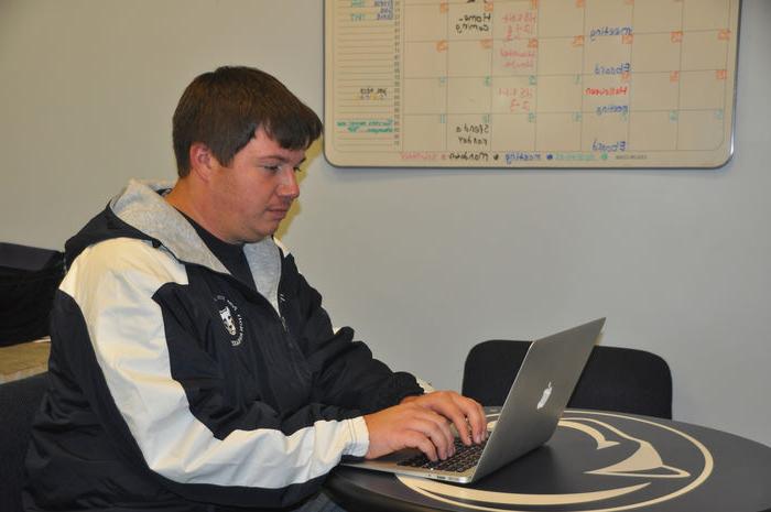 student typing on laptop